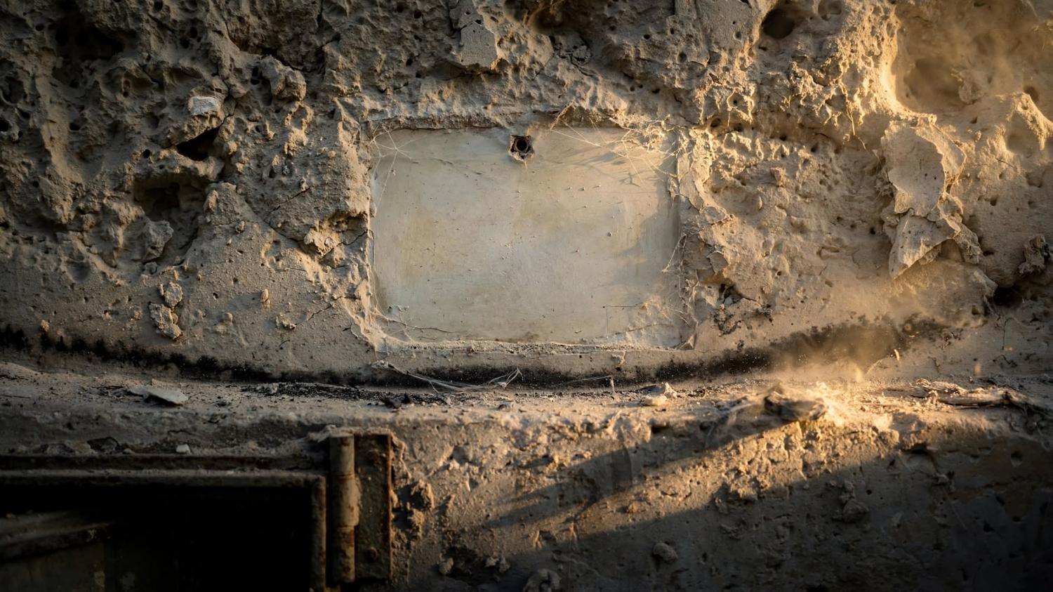 The empty rectangle, close. Cobweb, one nail hole, ash along the edge.