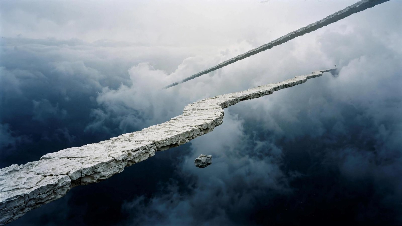 Two pale paths crossing in open sky, with no ground under either.